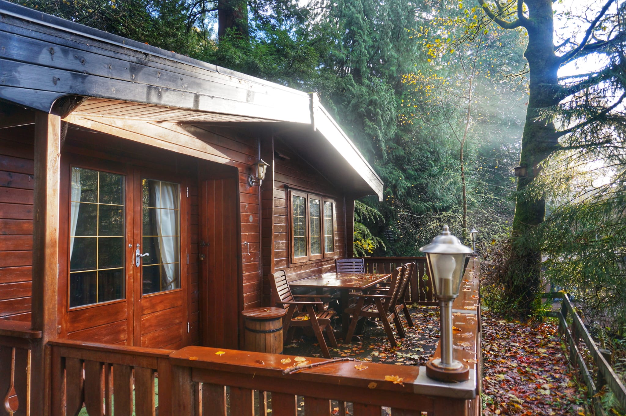 A wooden lodge and terrace among trees at base camp