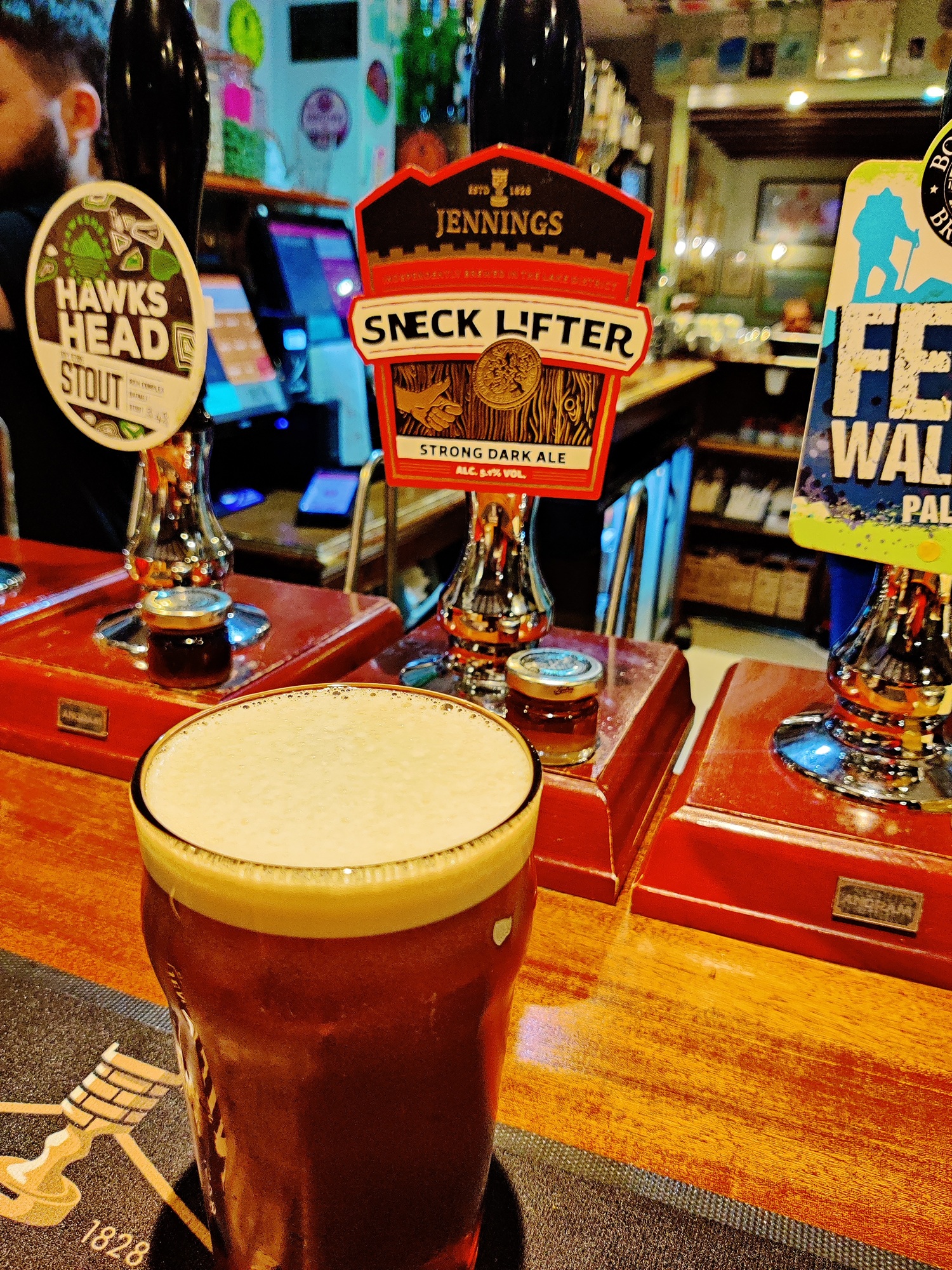A pint of ale beside Jennings Sneck Lifter hand pumps